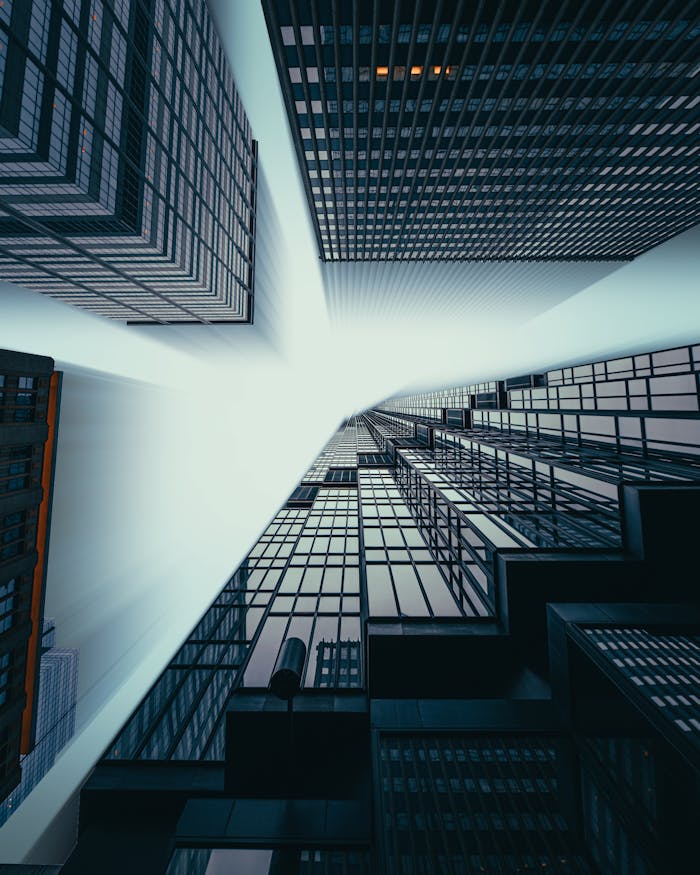 Striking low-angle perspective of skyscrapers in foggy Minneapolis, conveying urban mystery.