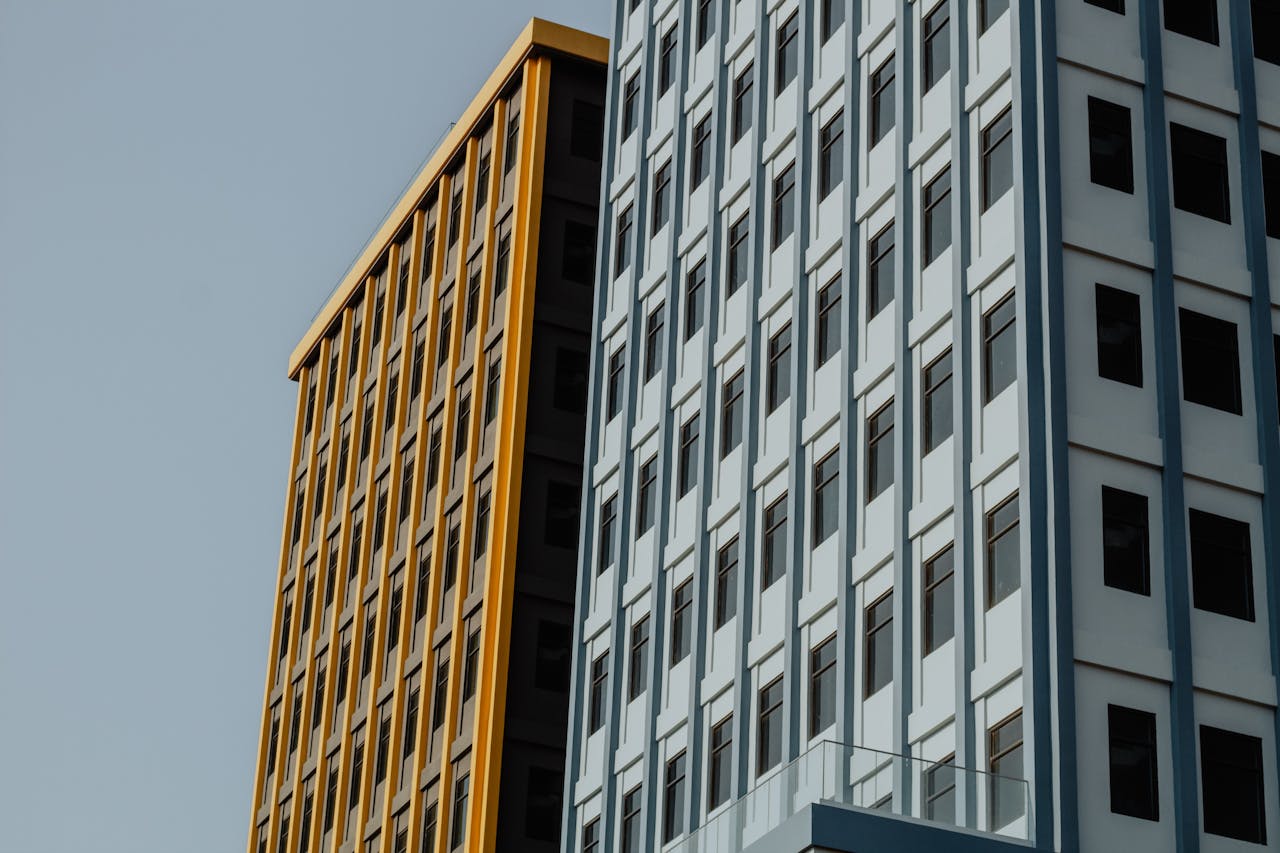 Low-angle view of modern building facades in Phnom Penh with contrasting colors.